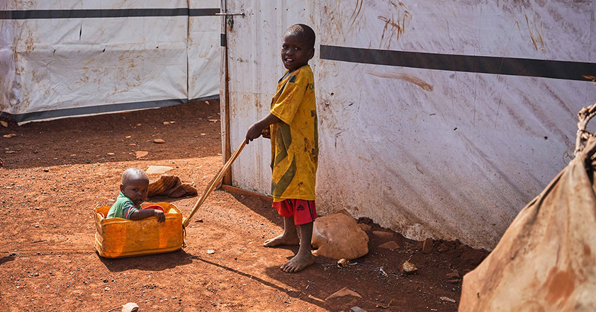 Boy pulling a younger child in a box