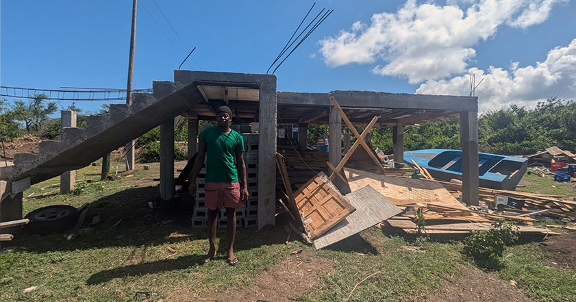 man stands by his destroyed home in the caribbean after hurricane beryl